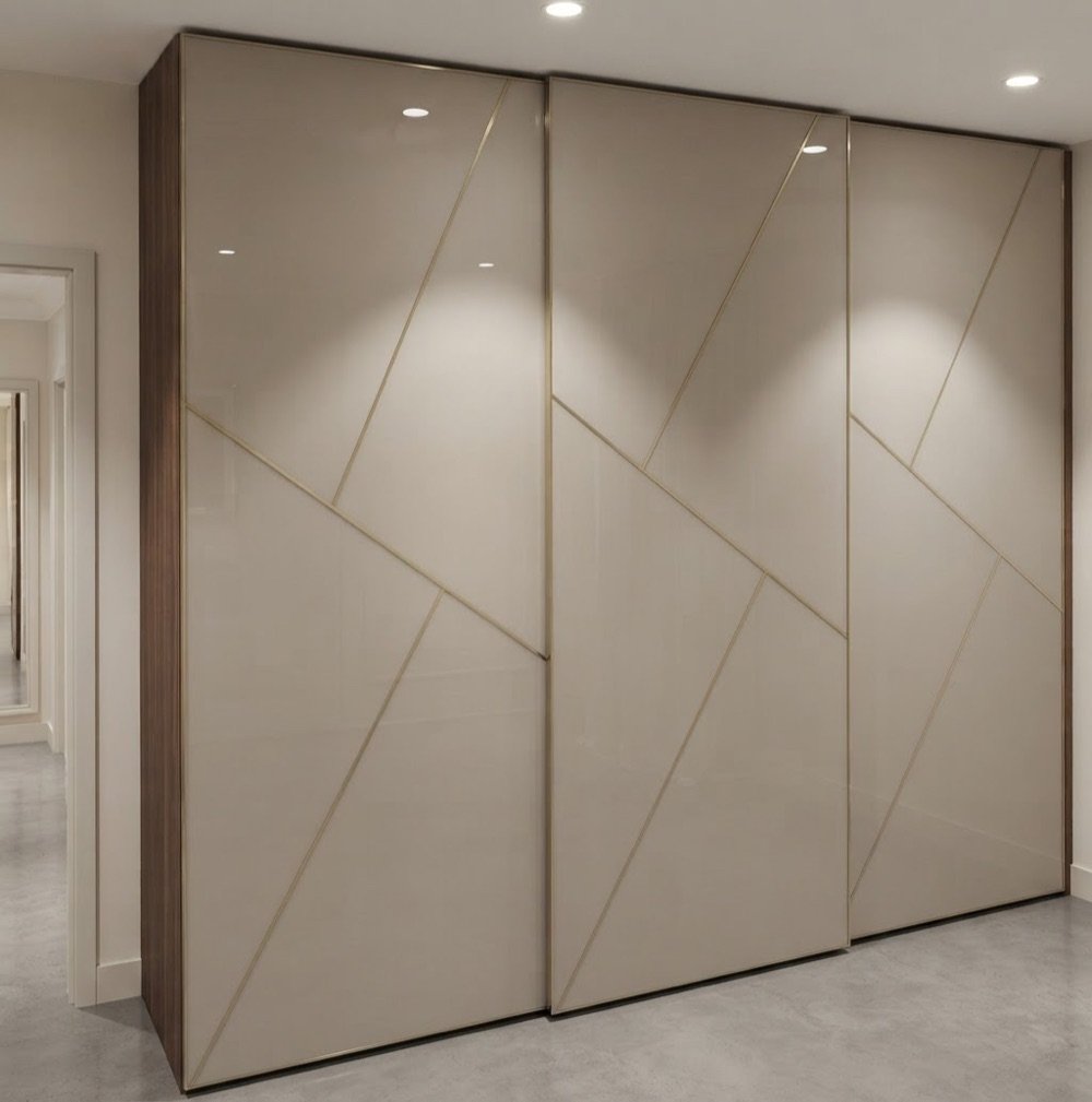 Full-height sliding wardrobe with champagne lacquered-glass doors and gold inlay in Hyderabad